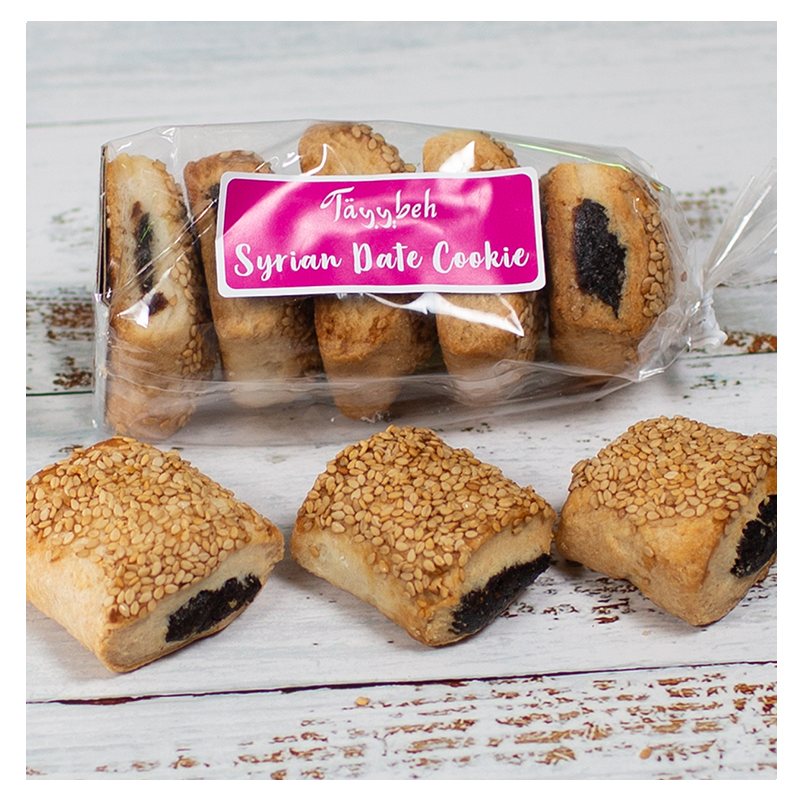 A package of Tayybeh Date and Sesame Cookies, featuring three delectable vegan cookies prominently displayed on a white wooden surface. An ideal choice for a healthy snack.