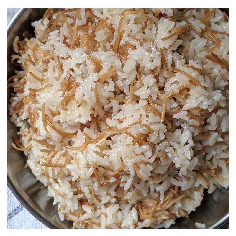 Tayybeh's Rice & Vermicelli offers a delightful blend of aromatic basmati rice and perfectly browned golden vermicelli noodles.